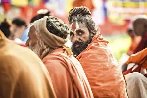 Sadhus, holy men, sitting around the Bodhi tree next to the Mayadevi Temple