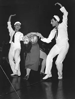 Two sailors dancing with woman in evening gown