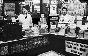 Two saleswomen standing behind the counter