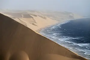Sand dunes and sea in evening light