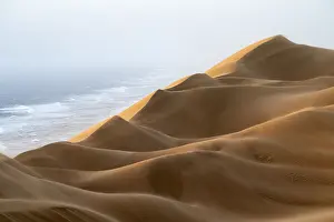 Sand dunes and sea in evening light