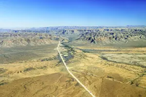 Sand road C26, disappearing between the mountains in the direction of Gamsberg Pass