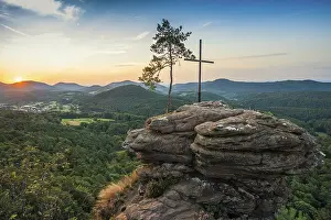 Sandstone rock with pine tree and summit cross