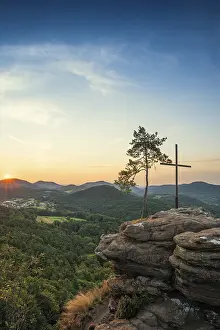 Sandstone rock with pine tree and summit cross
