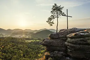 Sandstone rock with pine tree and summit cross