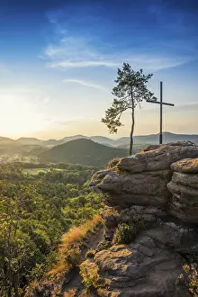 Sandstone rock with pine tree and summit cross