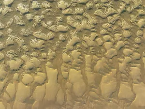 Sandy shapes at low tide at the shore of the Atlantic Ocean near Cape Trafalgar
