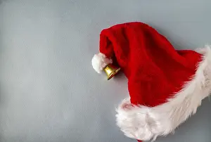Santa claus hat with bell on blue background