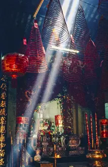 Scanned slide of a historical colour photograph with clouds of smoke from incense sticks inside a Buddhist pagoda