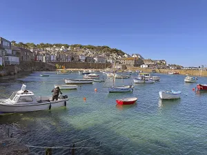 Framed Print : Scene in a busy harbour with people swimming and paddling in the water