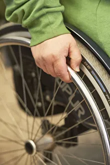 Scene with wheelchair user, with her hand on the wheel arch Wilhelmshafen, Bremen, Germany, Europe