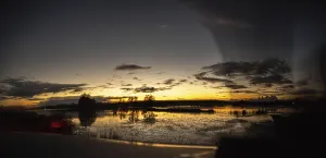 A scenic sunset view reflecting over water creating a tranquil landscape