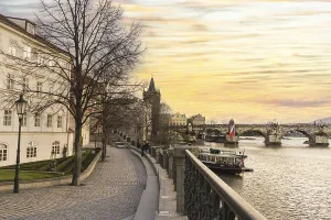 Scenic view of Charles Bridge and Moldava river at sunset in Prague