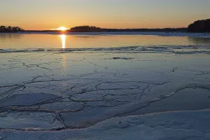 Scenic view of seashore at sunset in winter with frozen sea