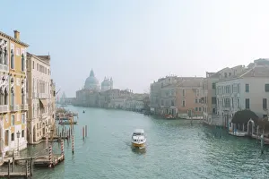 Scenic view of Venice's Grand Canal with a boat navigating the peaceful waters