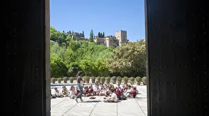 School children listen to their teacher on an educational visit to the historic sites of Granada