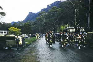 Scottish marching band with bagpipers in the Grampians National Park, Victoria, Australia 1956, probably in Halls Gap