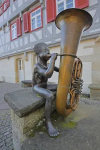 Sculpture boy with tuba by Guido Messer 1991