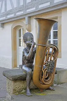 Sculpture boy with tuba by Guido Messer 1991