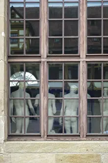 From behind sculptures, male figures