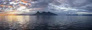 Sea and rocky mountain range, at sunset