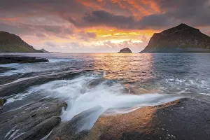 Sea surf in warm evening light with coastal landscape on Lofoten