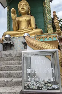 Seated Buddha with the money box for donations