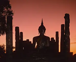 Seated Buddha at Wat Mahathat, silhouette at dusk