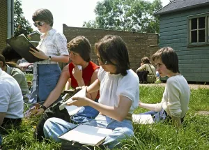 Secondary school girls doing fieldwork in geography, Great Britain 1970s Girls with clipboards sitting in the grass 1977
