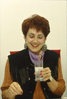 Secretary drinks glass of water with effervescent tablet Office scene