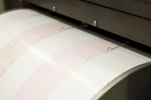 Seismograph records an earthquake on the sheet of measuring paper