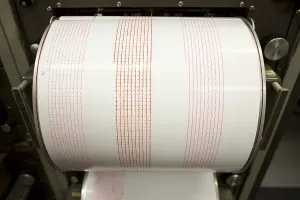 Seismograph records an earthquake on the sheet of measuring paper