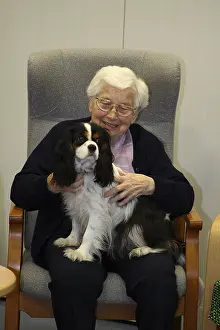 Senior citizen with Cavalier King Charles Spaniel