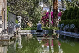 Senior citizen sitting by a pond in a beautiful park