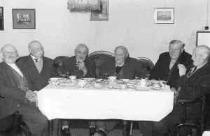 Eight senior citizens drinking coffee