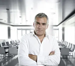 Senior expertise gray hair businessman posing interior white modern office