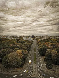 A sepia view of Berliner StraBe in autumn with dramatic sky conveying a nostalgic atmosphere