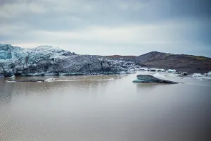 Serene landscape with icebergs and rocky terrain surrounding still water