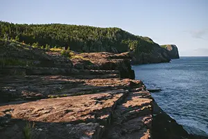 A serene view of the rugged cliffs descending into the ocean at Flatrock