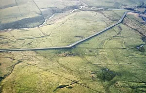 Series of oblique aerial views of sites associated with Hadrian's Wall, c. 1970s Outlines of structures in fields, undetermined location between Cawfields and the Roman fort of Great Chesters, Northumberland, England, UK
