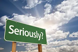 Seriously? green road sign over dramatic sky