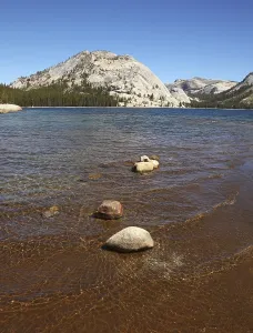 Shallow on the lake surrounded with mountains and woods