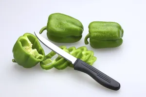 Sharp knife with black handle with slices of Green Capsicums Latin Capsicum Annuum