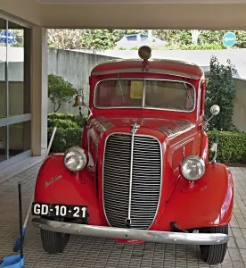 Shiny vintage Ford fire engine parked in a garage
