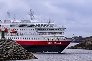 Ship Kong Harald of Hurtigruten company is approaching harbor of Stamsund