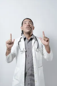 Shocked doctor looking up on isolated