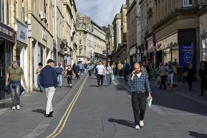 Shoppers walking in pedestrianised street in city centre