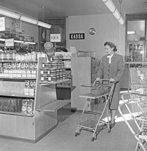 Shopping in the 1940s. A woman shops in a self service store