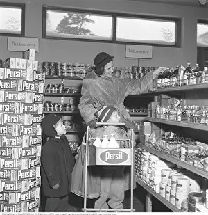 Shopping in the 1950s. A woman shops in a self service store