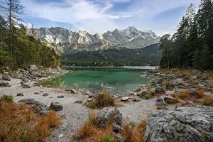 Shore with rocks, Eibsee lake with Zugspitze massif and Zugspitze